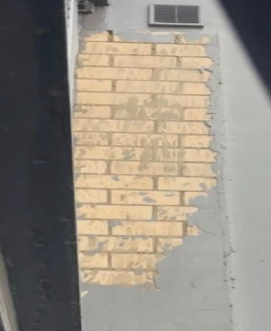 Failed render removed back to the brickwork on the Randwick hotel façade before patching