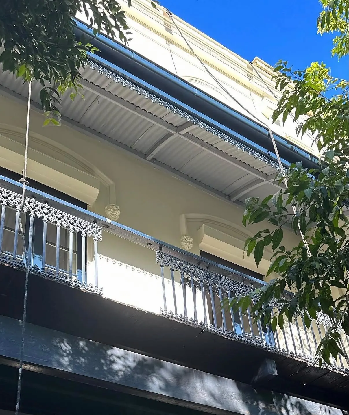 Redfern heritage terrace after repainting, with the iron lace balcony and awning